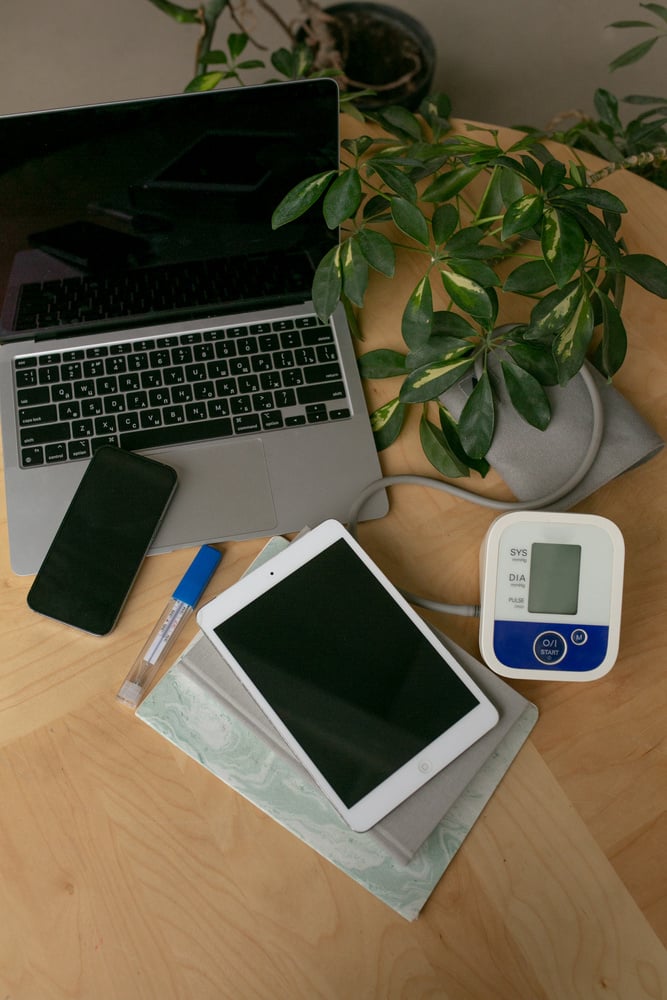 Green Medicine Flatlay of Laptop and Medical Equipment